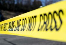 Judge Pushes Tesla Crash Toward Trial Yellow police tape stretched across an outdoor scene