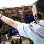 Cockpit Attack Twist: Iran Link Looming? Pilot adjusting controls in an airplane cockpit