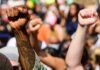 Raised fists at a crowded protest