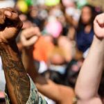 Raised fists at a crowded protest