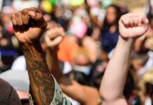 Raised fists at a crowded protest
