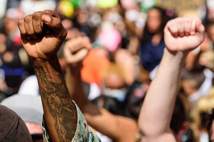 Raised fists at a crowded protest