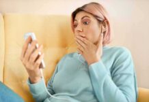 Mystery Text Blast Riles Texas Parents – Who Pushed This Toolkit? Person with earbuds looking at phone in surprise on a yellow couch