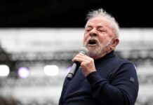 Luiz Inácio 'Lula' da Silva speaking into a microphone on stage