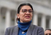 woman in glasses speaking outdoors