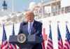 Power Play: Trump Zeroes In On Nebraska Donald Trump speaking at a podium with American flags and a ship in the background