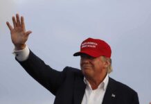 Red Tape Killer – Trump Forces One-Door Government Overhaul Donald Trump waving in a red cap