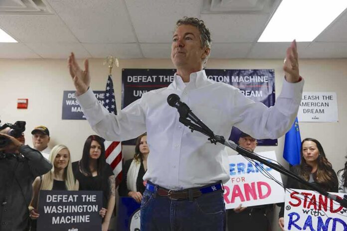 shutterstock_353101016 Rand Paul speaking at a campaign event with supporters holding signs