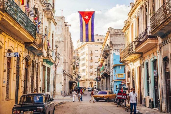 shutterstock_412724059 Cuban flag over colorful old Havana street