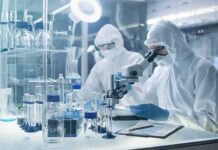 Cheap Hydrogen From Sunlight – What Changed? Scientists in protective suits using a microscope in a laboratory